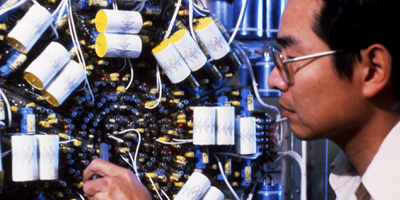 A CPES researcher inspects a piece of equipment.